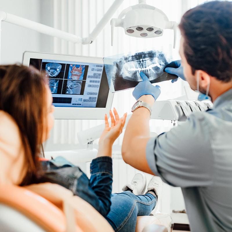 patient and dentist looking at xray in Denham Springs, LA